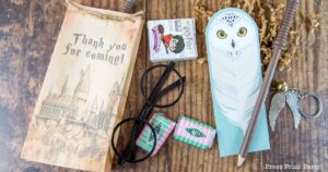 Harry Potter party favors Hedwig bookmark, wand pencil, honeydukes mini chocolates, golden snitch, and Hogwarts favor bag.