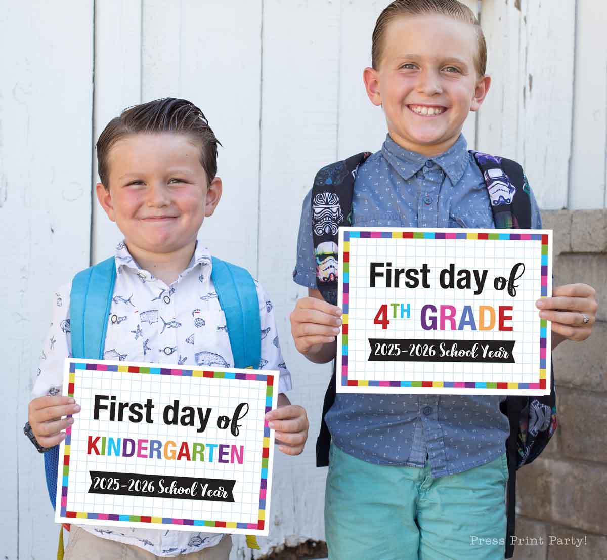 Two young boys with backpacks smile while holding first day of school signs. One sign says, "First day of Kindergarten, 2025-2026 School Year," and the other, "First day of 4th Grade, 2025-2026." Perfect for first day of school printable memories.
