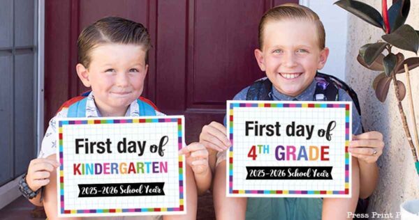 Two smiling boys sit on a doorstep holding colorful first day of school signs. The younger boy’s says "First day of Kindergarten, 2025-2026," while the older boy’s sign marks his "First day of 4th Grade." Perfect for your own first day of school printable memories!.