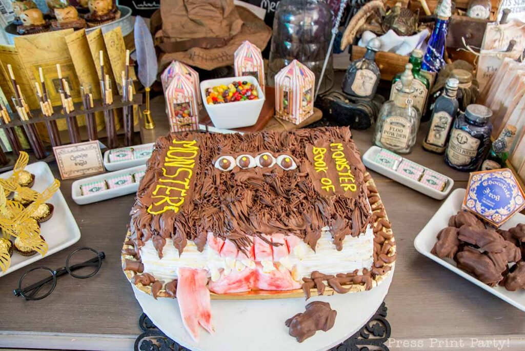 monster book of monsters cake on table with chocolate frog - Press Print Party