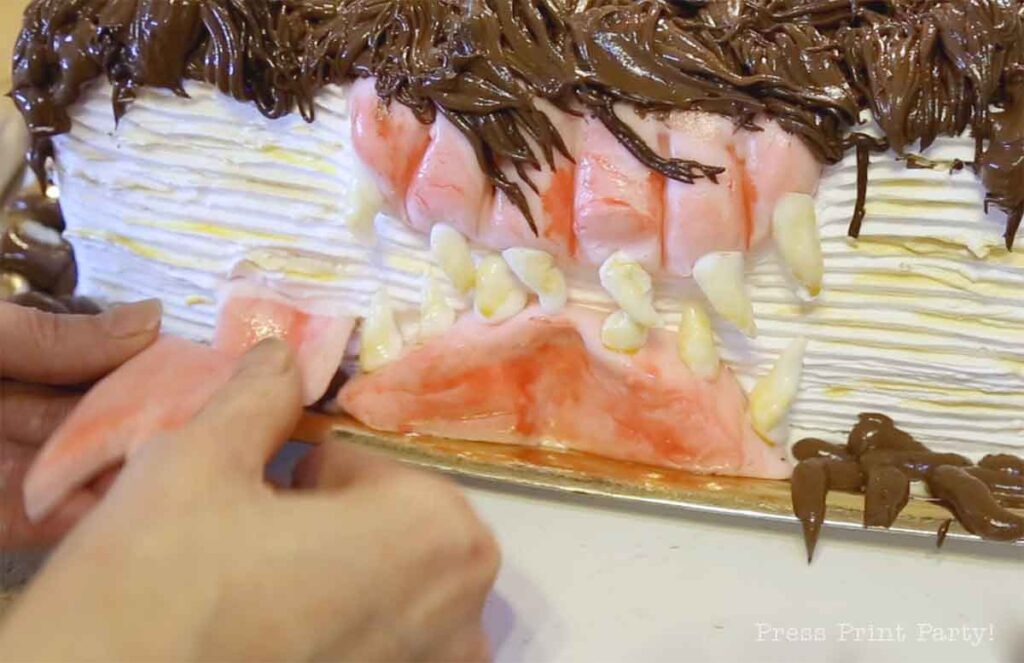 close up of putting tongue in monster book of monsters cake - Press Print Party