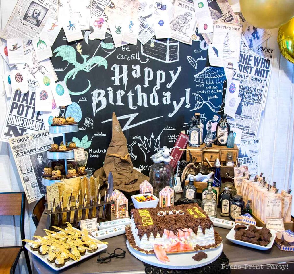 harry potter birthday party dessert table with monster book of monsters cake and lots of decorations - press print party