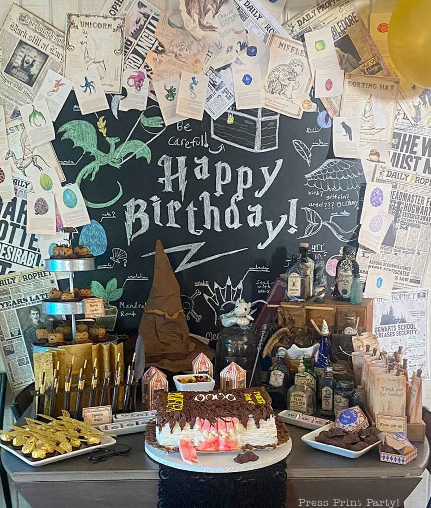 harry potter birthday party dessert table with monster book of monsters cake and lots of decorations - press print party