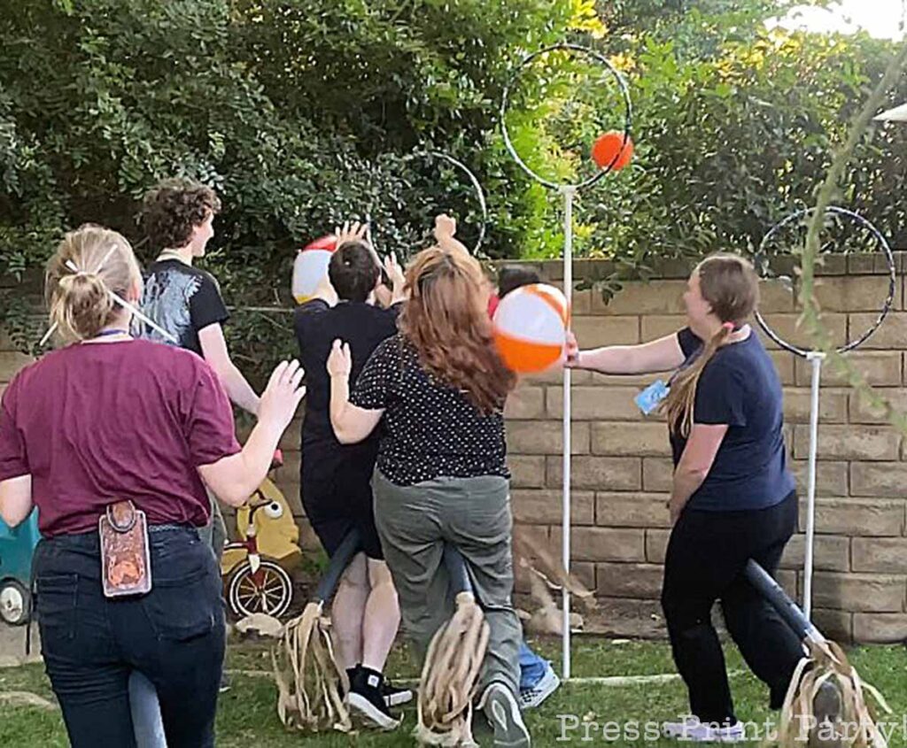 kids playing backyard quidditch game