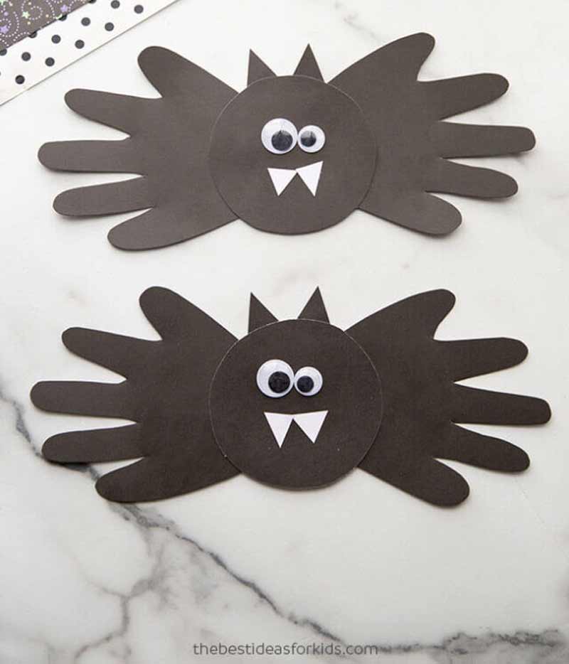 a paper bats with handprints and teeth