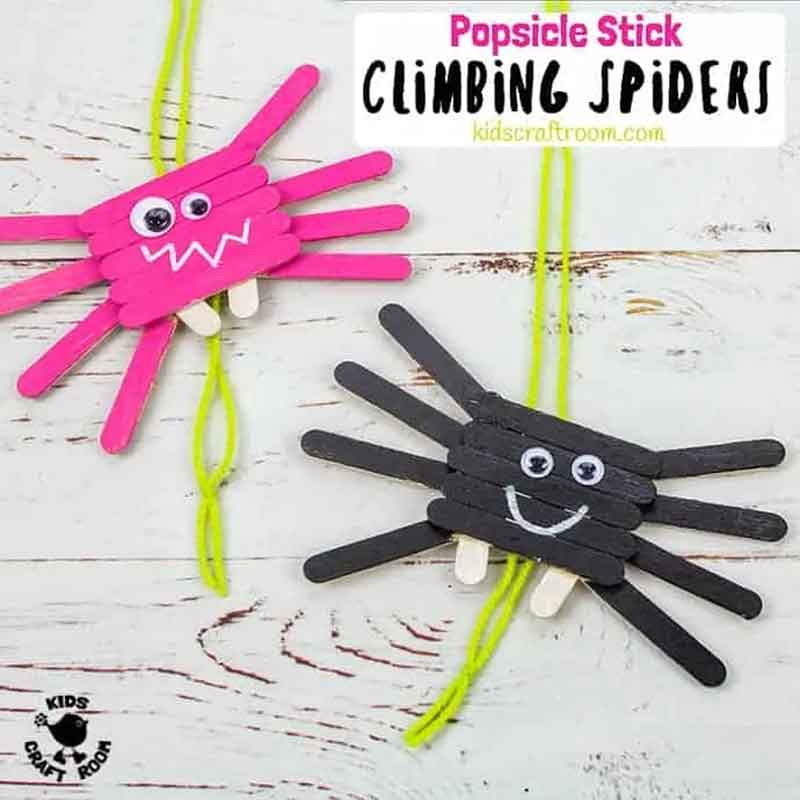 climbing spider craft with Popsicle sticks painted pink and black.