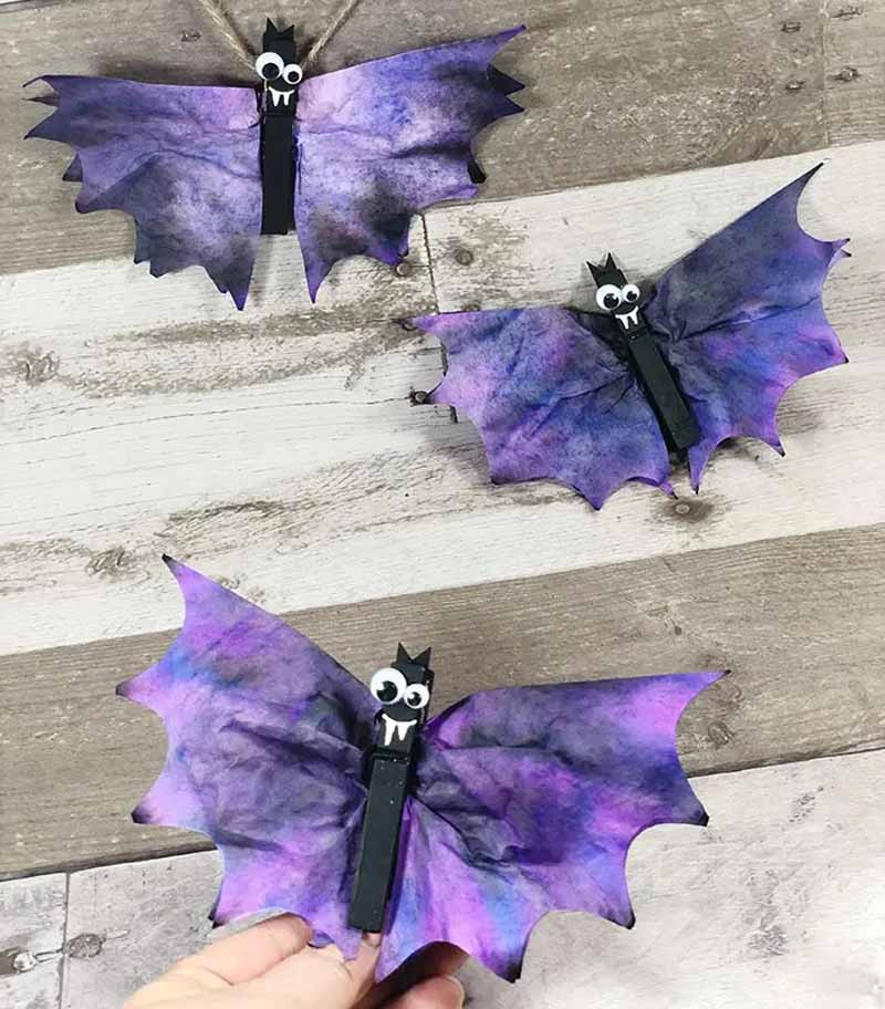 a group of purple and purple bat shaped objects made with coffee filters