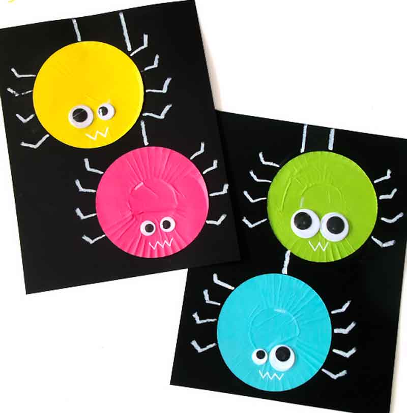 painted spiders on black paper