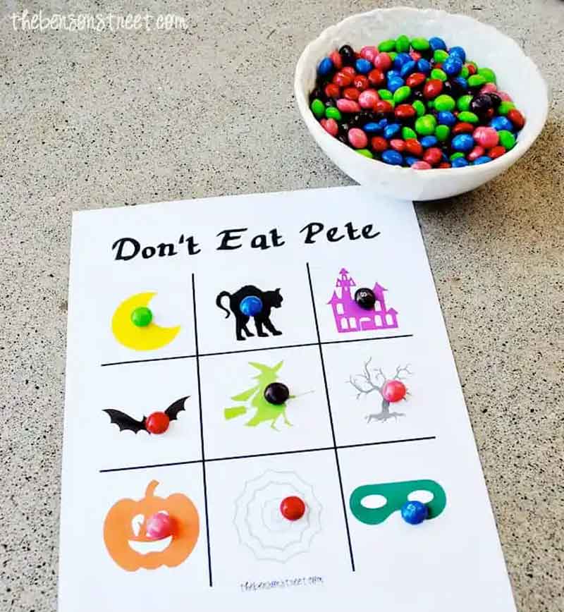 Halloween game board don't eat pete on a table next to a bowl of candy