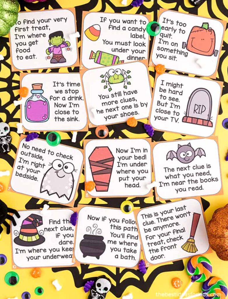 Halloween-themed scavenger hunt clue cards with playful illustrations, including a Frankenstein, candy corn, pumpkin, spider, tombstone, ghost, mummy, bat, witch's hat, cauldron, and broomstick, scattered on a yellow and black background decorated with small Halloween items like bones, skulls, and candy