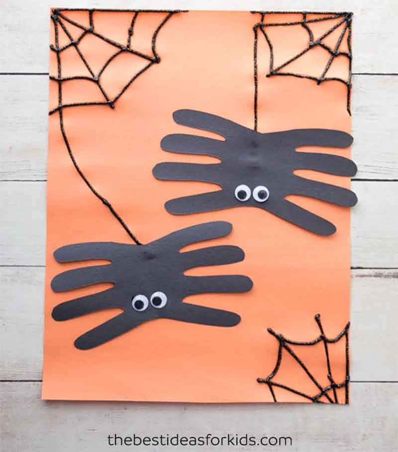 spider handprint crafts on orange paper