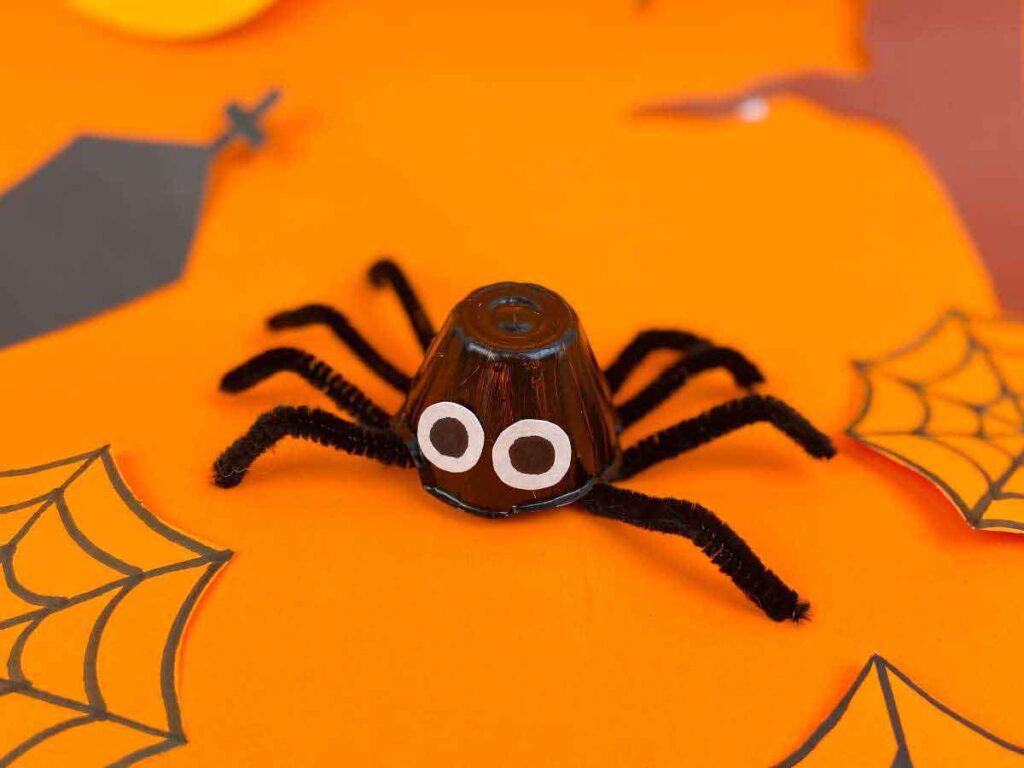 egg carton spider craft on orange paper