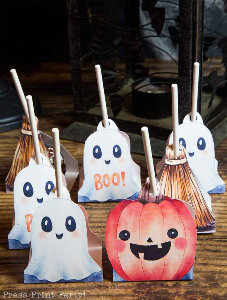 cute ghost and pumpkin and brooms with lollipops