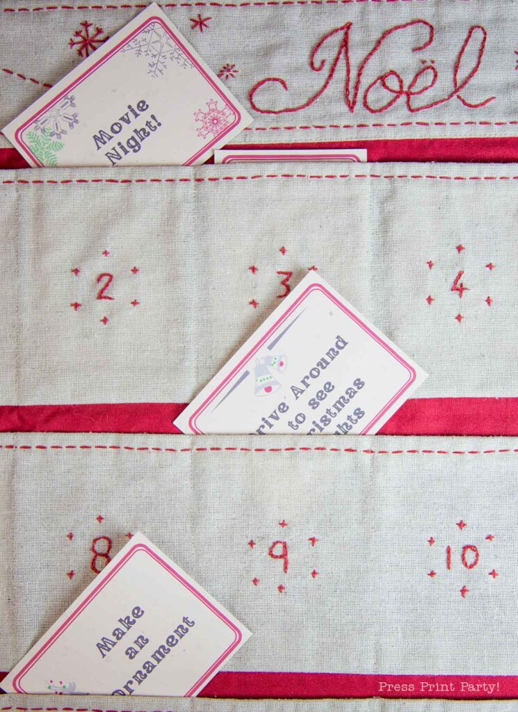 A fabric advent calendar with red embroidery and pockets numbered 1 to 10. Pockets contain activity cards that say "Movie Night," "Drive Around to See Christmas Lights," and "Make an Ornament." The word "Noel" is embroidered at the top.