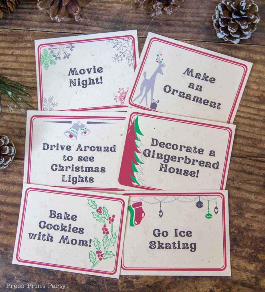A charming Advent calendar activity ideas set features six holiday activity cards on a wooden surface, surrounded by pine cones and branches. The cards read: "Movie Night!", "Make an Ornament", "Drive Around to see Christmas Lights", "Decorate a Gingerbread House!", "Bake Cookies with Mom!", and "Go Ice Skating".