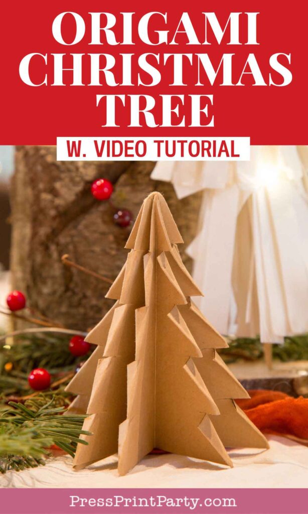 A brown folded paper Christmas tree sits on a table adorned with festive decorations, including red berries and greenery. The text above reads "Origami Christmas Tree w. Video Tutorial" on a bright red banner.