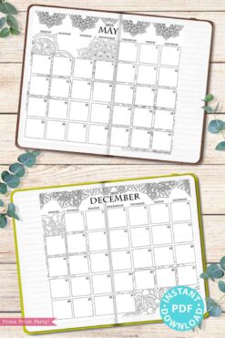 A stylish 2025 monthly planner showcases ornate floral designs at the top of its May and December pages. Placed on a wooden surface surrounded by green leaves, this elegant planner also features a preview of the 2025 One Page Calendar at-a-glance Printable Mandala. A circular "Instant PDF Download" label is elegantly placed in the bottom corner.