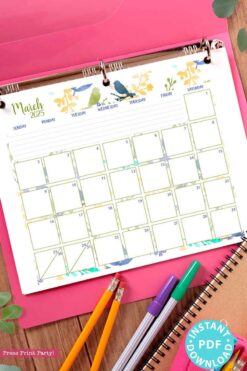 A page from the March 2025 calendar, secured in a pink binder and adorned with a decorative bird and floral watercolor design, offers a glimpse into the allure of the 2025 Calendar Bundle for Bullet Journals or Binders. Colorful pens and pencils lay beneath, while a blue sticker on the bottom right announces 