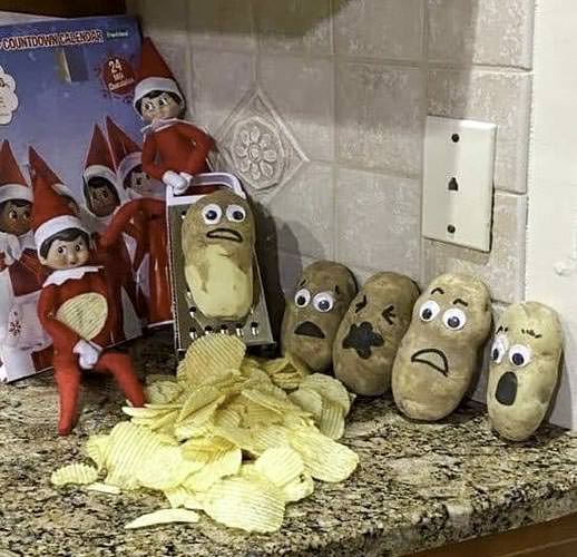 Elves use a grater on a potato with a surprised face, creating a pile of potato chips. Nearby, other potatoes display expressions ranging from shocked to sad. An elf-themed advent calendar stands in the background on a kitchen counter.