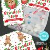 The "Mrs. Claus Bakery Christmas Treat Bag Topper & Tag" features charming reindeer-themed designs perfect for "Reindeer Soup," displayed alongside marshmallows. It includes customizable text areas and illustrations of a reindeer and holiday decorations, with options for Merry Christmas and Happy Holidays messages.