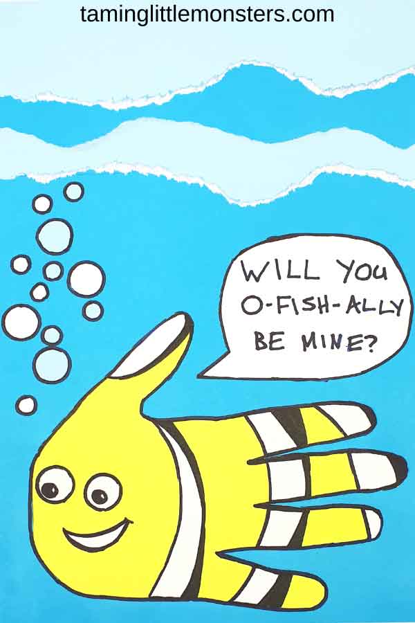 A hand-painted yellow fish with black stripes and a smiling face swims in a blue sea with bubbles. A speech bubble from the fish reads, "Will you o-fish-ally be mine?" White wave lines are at the top.