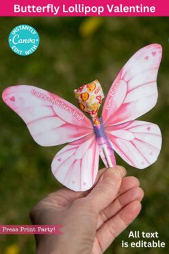 A hand holds a butterfly-shaped lollipop with pink wings, wrapped in colorful paper. Text: "Butterfly Lollipop Valentine," "Press Print Party!" and "All text is editable." Product Name: template (Copy) (Copy).