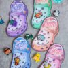 Five colorful Valentine-themed cards shaped like Crocs shoes, each adorned with cute charms like animals and tractors. The text reads "You Croc!" and "Happy Valentine's Day from [Name]." Product: template (Copy) (Copy).