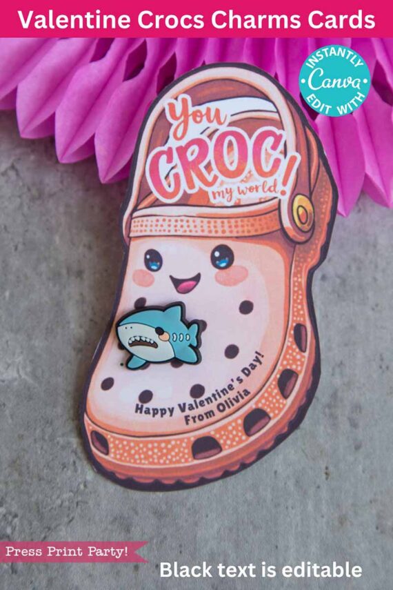 A Valentine's card titled "template (Copy) (Copy)" is shaped like a Croc shoe with a smiling cartoon face, rosy cheeks, and a shark charm. It reads "You Croc my world! Happy Valentine's Day! From Olivia," set against a pink textured background.