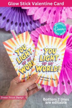 A hand holds two vibrant Valentine cards featuring glow sticks, each with the message "You Light Up My World!" set against pink decorations. The image text emphasizes customization features for these template (Copy) (Copy) cards.