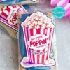The "template (Copy) (Copy)" sticker features a popcorn Valentine theme with "Have yourself a Poppin' Valentine's Day" and "From Olivia" text, showcasing a red and white striped popcorn box illustration against a pink ribbon background. Perfect for popcorn bags!.