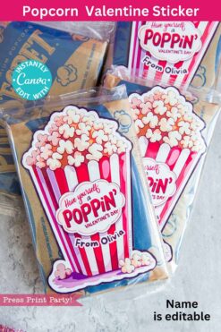 Valentine's Day-themed popcorn gift bags featuring a pink and red popcorn box design with the message "Have yourself a Poppin' Valentine's Day from Olivia." The name "Olivia" can be customized. Product Name: template (Copy) (Copy).