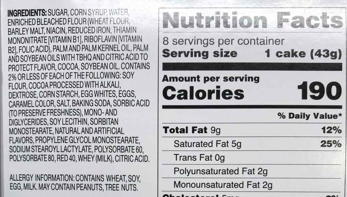 Image of a nutrition label for a cake. It lists ingredients including sugar, flour, eggs, and milk. Each serving (43g) has 190 calories, with 9g of total fat. The label includes vitamins and minerals, like iron and folic acid.