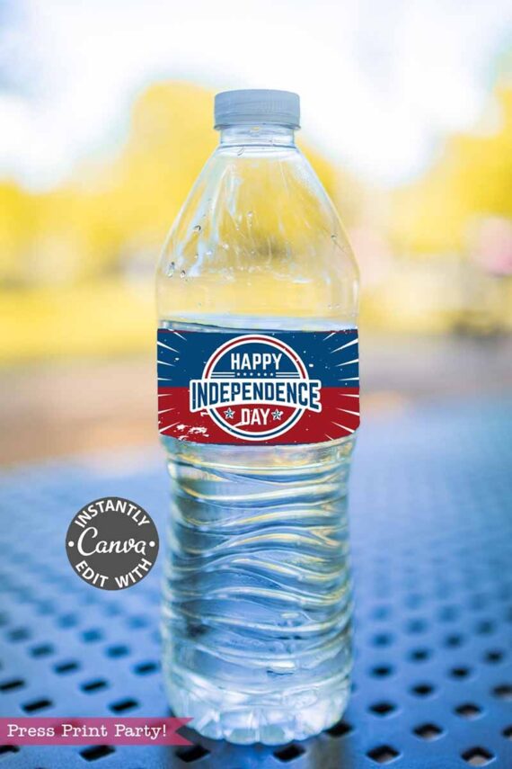 A plastic water bottle featuring a "Happy Independence Day" label in red, white, and blue sits on a blue metal table outdoors. The Canva logo and "Press Print Party!" appear in the corner. Product shown: template (Copy) (Copy).