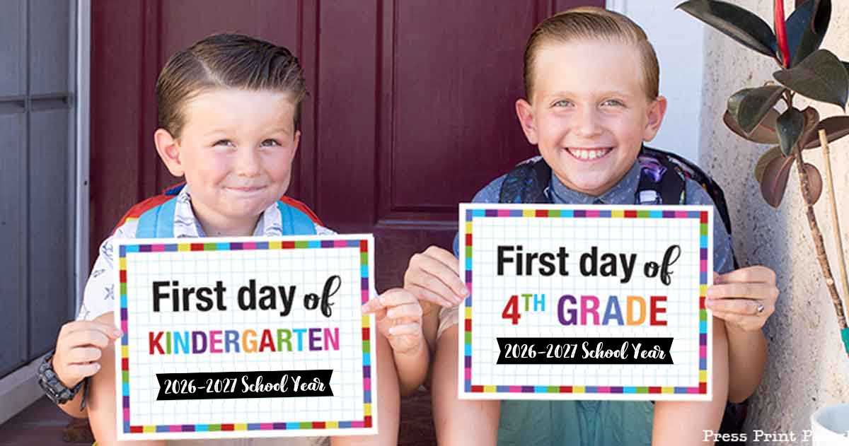Two smiling children sit on a porch holding colorful first day of school signs. The younger’s sign reads “First day of Kindergarten 2026-2027,” while the older holds a “First day of 4th Grade 2026-2027” first day of school printable.