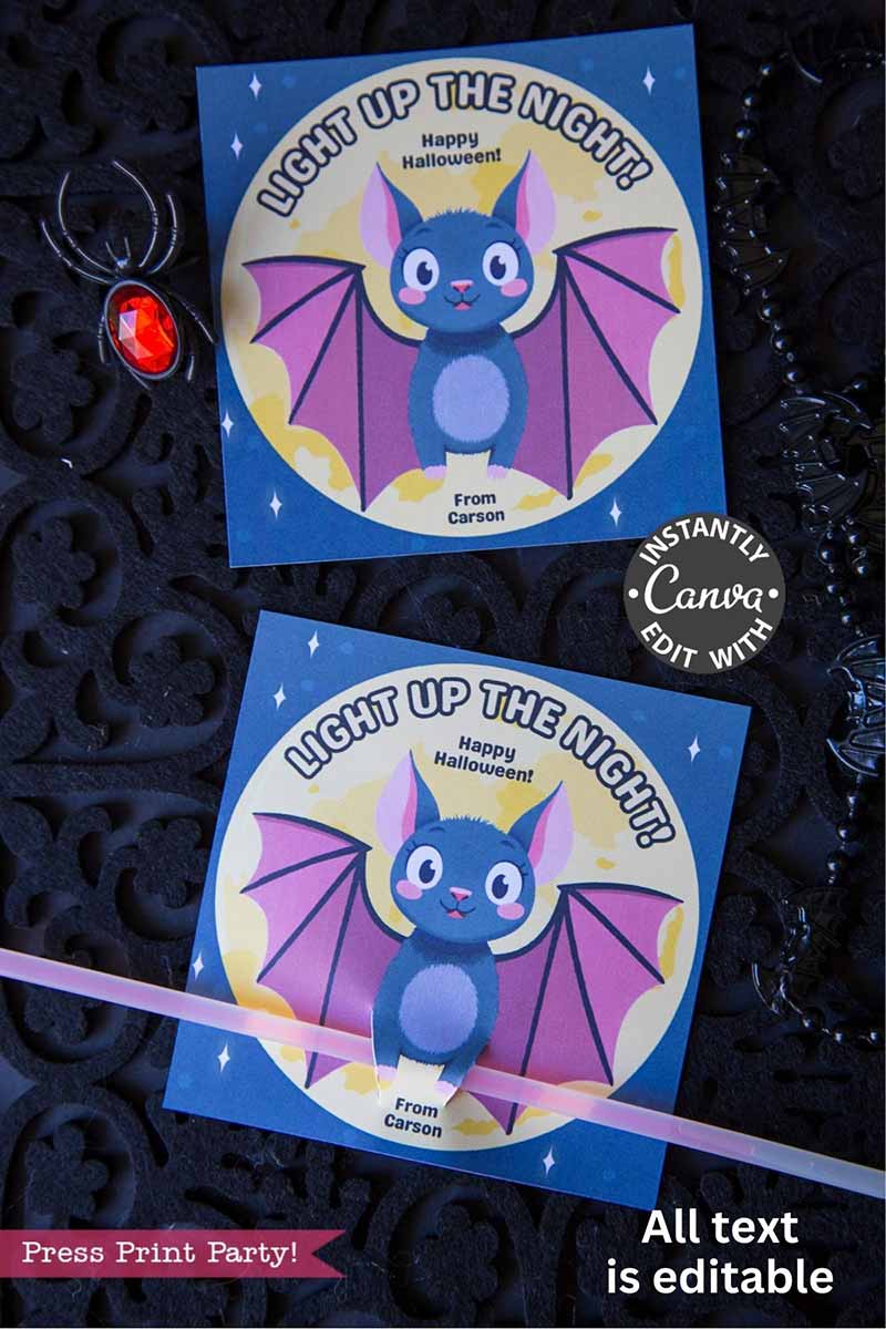 A Cute Ghost Halloween Gift Card Holder with a cartoon bat, purple wings, and "Light Up The Night! Happy Halloween! From Carson." Editable and printable; perfect for gifting. Shown on a dark surface with jewelry nearby.