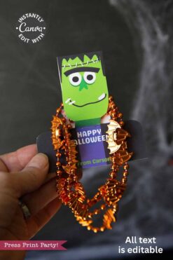 A hand holds the Cute Ghost Halloween Gift Card Holder featuring a cartoon Frankenstein face, orange bat beads, Canva sticker, “Happy Halloween,” “From Carson,” and a note: