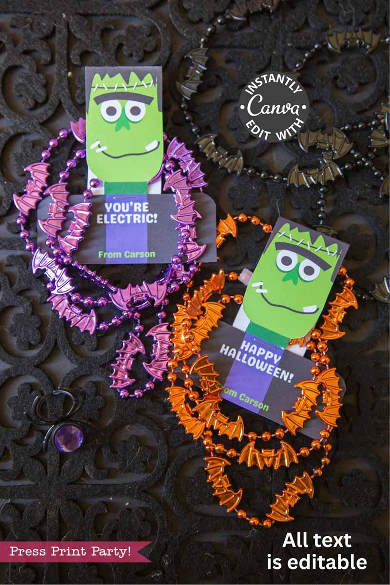 The Cute Ghost Halloween Gift Card Holder features a green Frankenstein cartoon and ghost accents with phrases like "You're Electric!" and "Happy Halloween!" and comes attached to purple and orange bat-shaped necklaces.