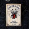 The Cute Ghost Halloween Gift Card Holder features a spider and web design with "Creeping It Real" and "Happy Halloween! From Carson." A black plastic spider with a red gem body adds a spooky touch on its textured surface.