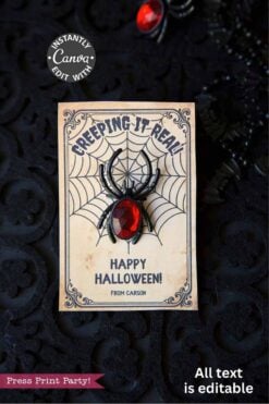 The Cute Ghost Halloween Gift Card Holder features a spider and web design with "Creeping It Real" and "Happy Halloween! From Carson." A black plastic spider with a red gem body adds a spooky touch on its textured surface.
