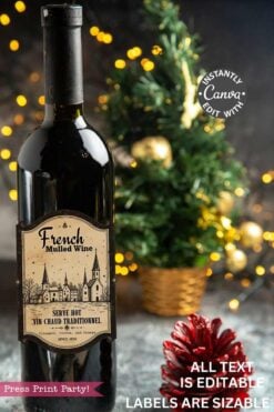 A set of Vintage Christmas Stickers Printable - Set 1 sits on a festive table near a small decorated tree with twinkling lights. The stickers feature snowy village scenes and churches, with editable label options for customization.