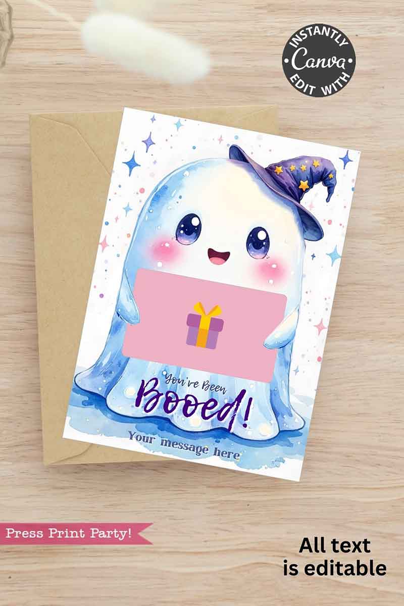 The Cute Ghost Halloween Gift Card Holder features a smiling cartoon ghost in a purple witch hat holding a pink sign with a gift box and "You've been Booed!" All text is editable. The card comes with a tan envelope.