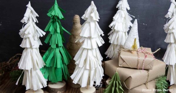 A group of paper trees creates charming christmas tree table decor, perfect for adding a festive touch to any setting.