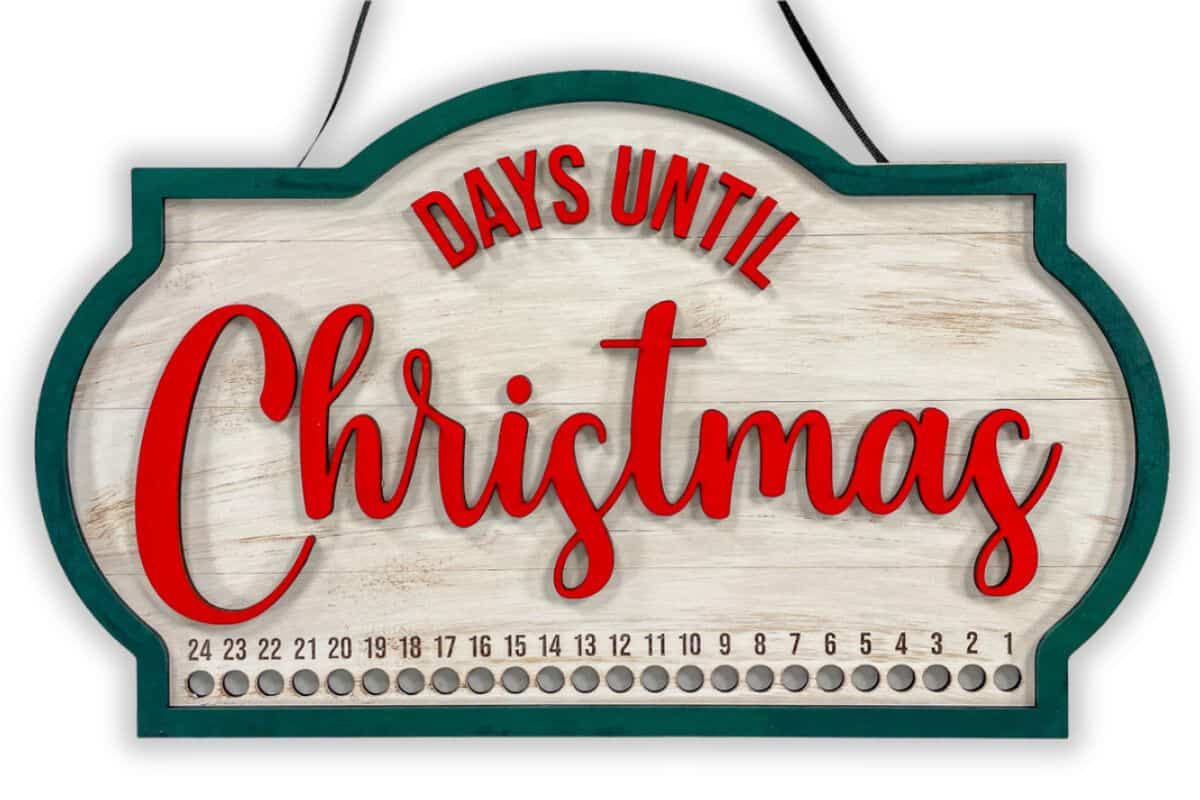 A decorative sign that reads "Days Until Christmas" with a row of numbered circles from 24 to 1 along the bottom for counting down the days. The word "Christmas" is written in large, red script.