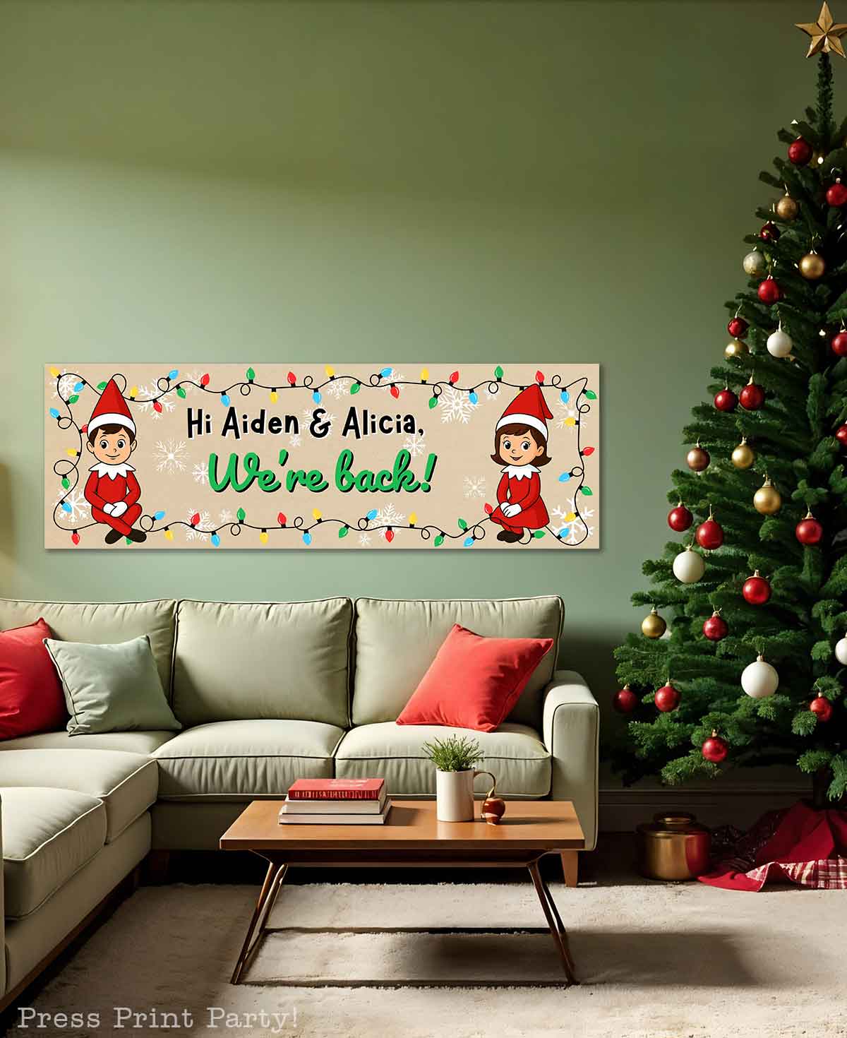 A festive living room with a decorated Christmas tree, a green sofa with red and white pillows, and a holiday banner on the wall featuring elves and the message, "Hi Aiden & Alicia, We're back!" with colorful lights.