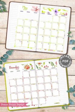 The 2026 Calendar Set & Habit Tracker, featuring watercolor floral designs, displays open May and December monthly planners on a wooden surface with greenery, each showing a floral-topped calendar grid and lined note sections.