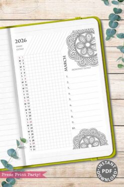 The 2026 Calendar Set & Habit Tracker, featuring watercolor floral designs, is open to a March goals page with daily and monthly sections on a wooden surface. A green cover, decorative leaves, and a pink label are also visible nearby.