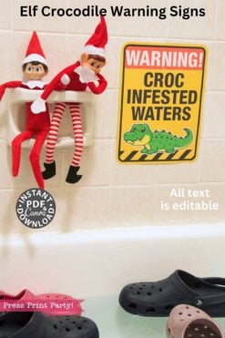 The Christmas Elf Croc Warning Sign Bathtub Prank features two toy elves on a soap dish above a "Warning! Croc Infested Waters" sign with a cartoon crocodile, plus Crocs shoes by the tub for a playful, humorous touch.