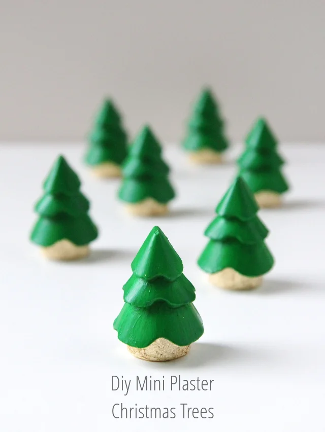 Eight small, green, tiered plaster Christmas tree decorations with beige bases are arranged on a white surface. The text below them reads: "Diy Mini Plaster Christmas Trees.