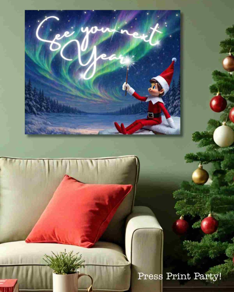A cozy living room with a green wall, beige sofa, red pillow, and decorated Christmas tree. Festive printable Elf on the Shelf props add charm to the scene, including a picture of an elf in a Santa hat writing “See you next year” in the northern lights.