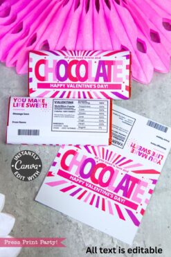 A Valentine’s Day chocolate bar with a pink and white wrapper sits on a card with custom text, next to the Valentines Day Socks Wrap Printable, another Choceur dark chocolate bar, and a crocheted heart.